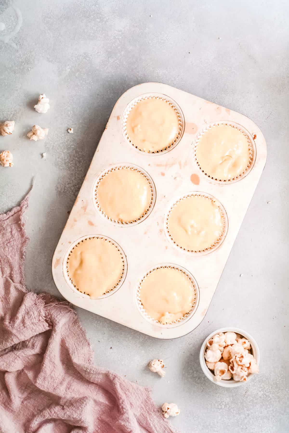 Cupcake batter filled in a muffin tin.