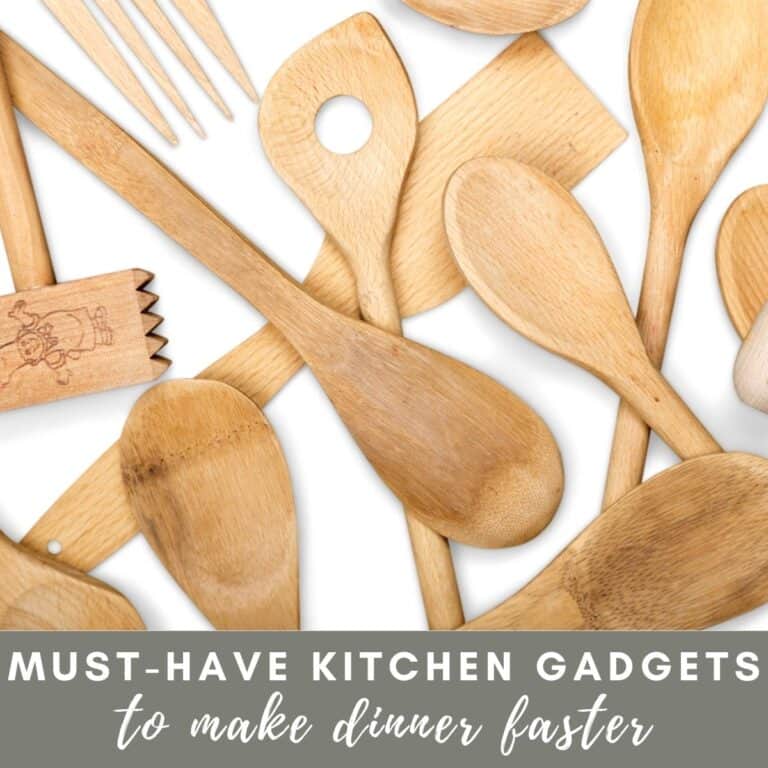 A variety of wooden cooking spoons on a white table.