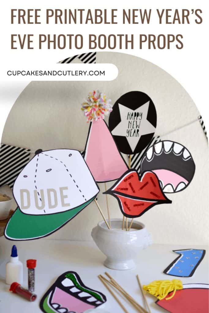Printable photo booth props for New Year's Even in a small vase on a table.