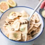 Bowl of ravioli in lemon butter sauce.