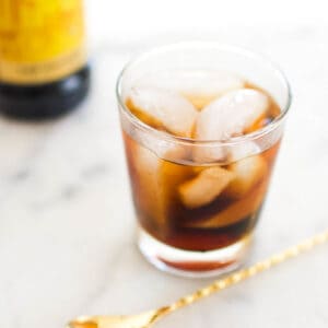 Close up of a Black Russian Cocktail recipe in a short glass on a counter.