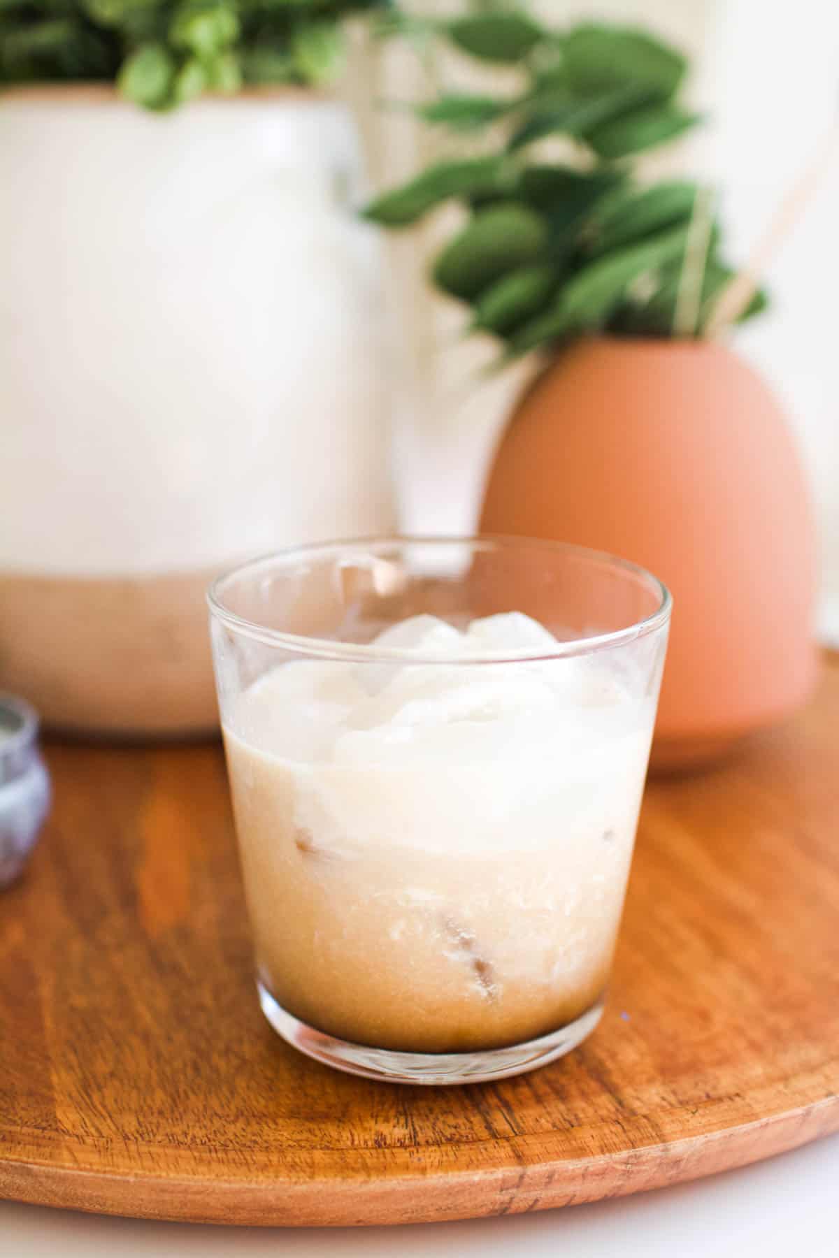 A White Russian with kahlua and vodka in a glass.