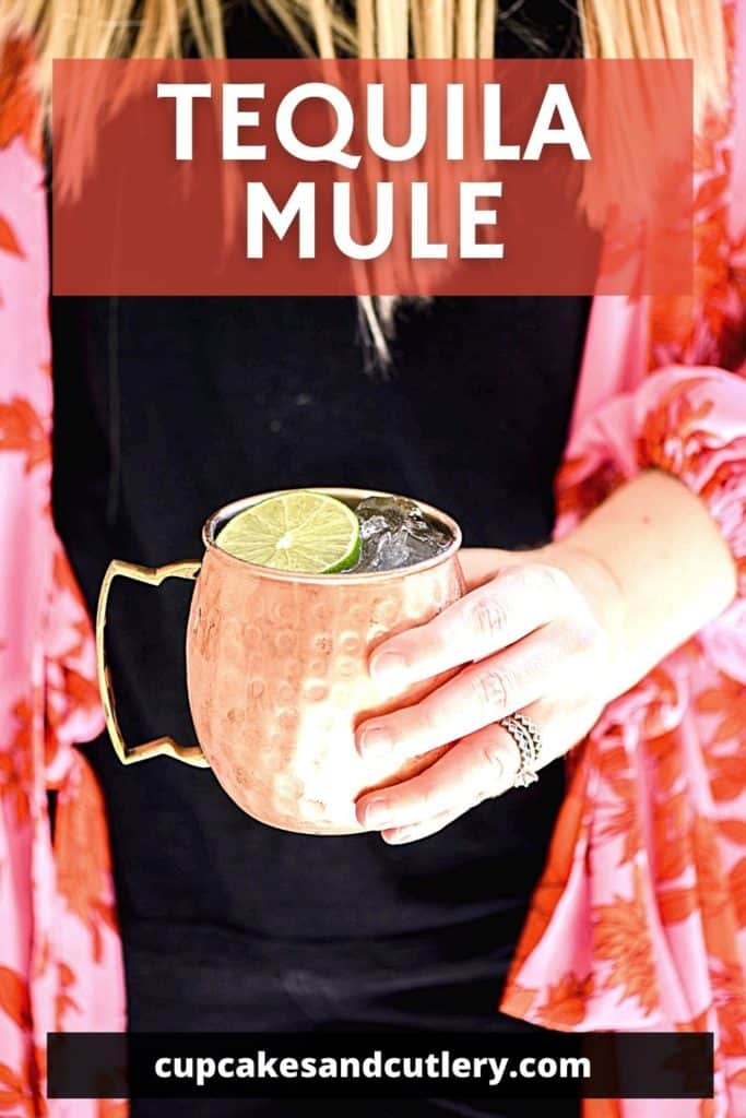 Woman holding a copper Moscow Mule mug with a Tequila Mule cocktail and text that says "Tequila Mule"