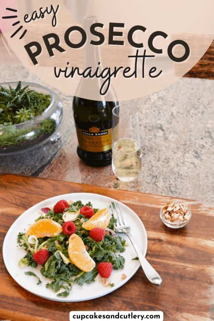 Text - Easy Prosecco Vinaigrette with a plate of kale salad on a cutting board next to a bottle of Prosecco and a glass of sparkling wine.