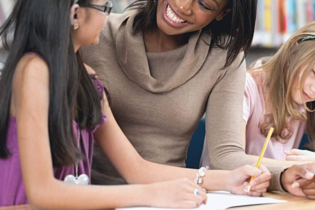 A teacher helping some students.