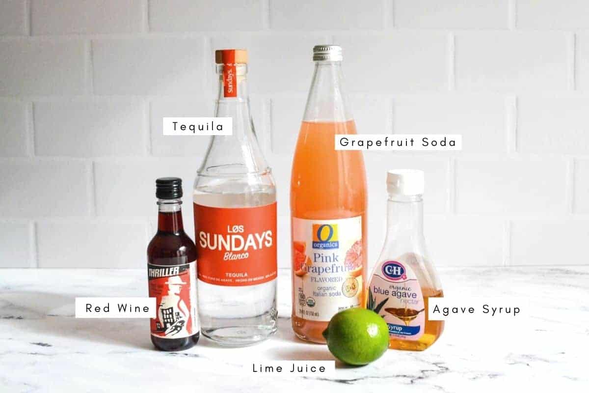 Ingredients for making red wine and tequila cocktails on the kitchen counter.