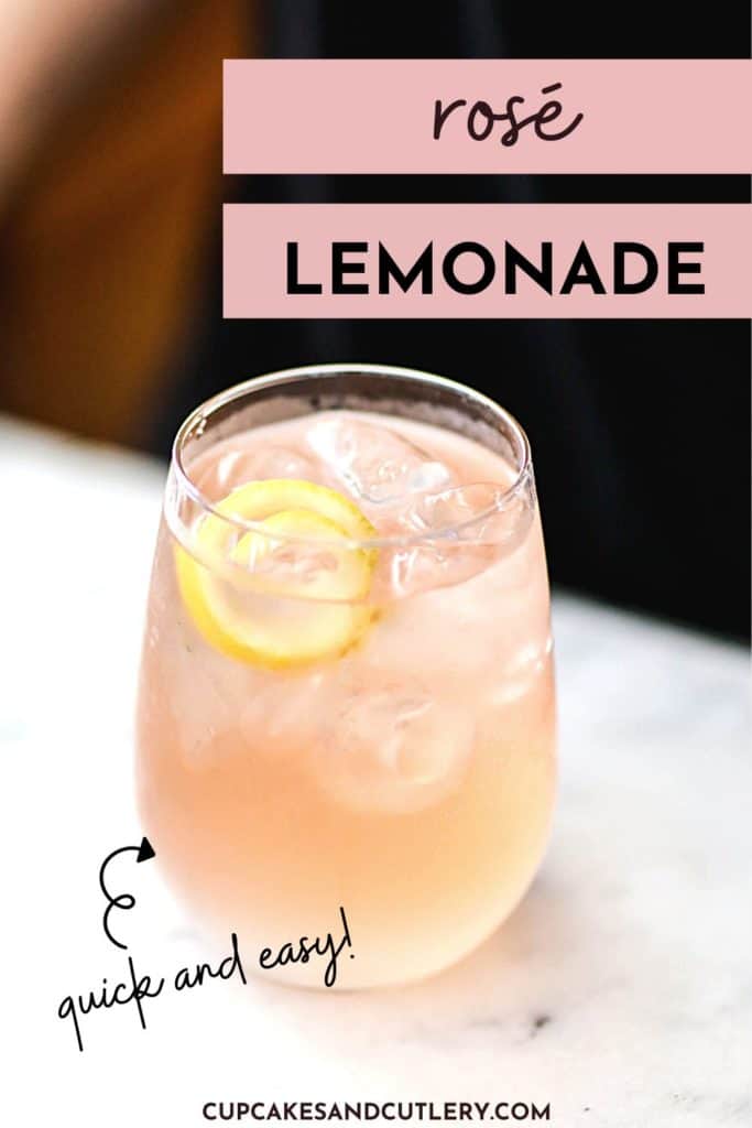 Text - Rosé lemonade with a stemless wine glass holding a cocktail on a table with a lemon spiral garnish.