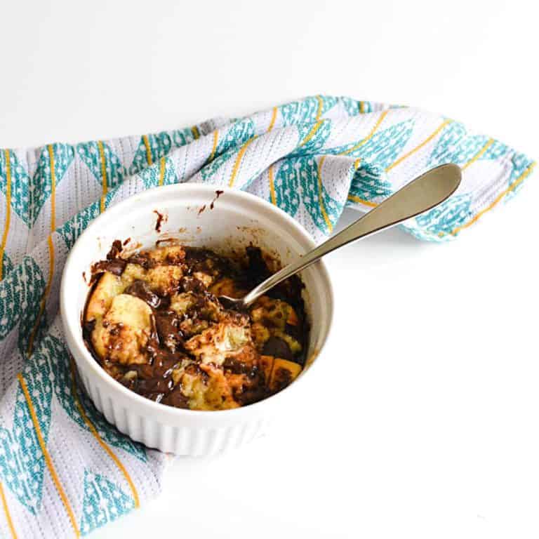 A microwave bread pudding in a white ramekin.
