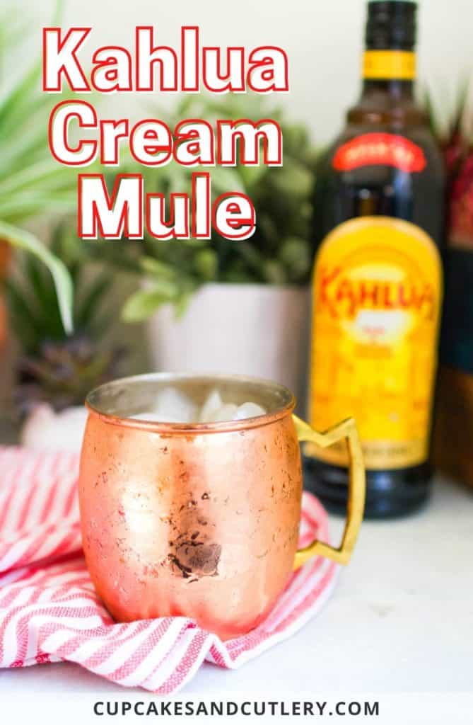 Copper mug on a table in front of a bottle of Kahlua with text that says "Kahlua Cream Mule".