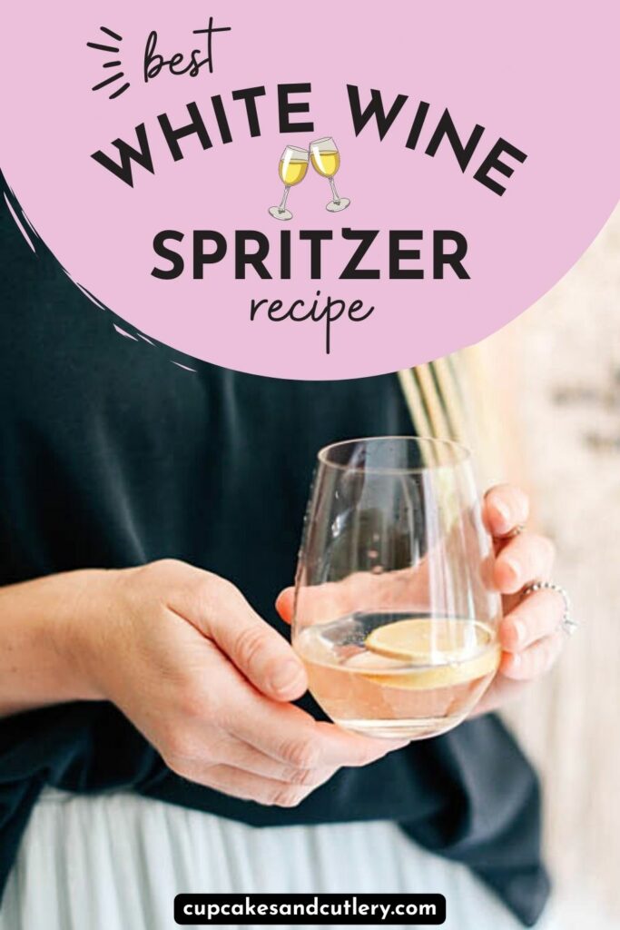 Woman holding a stemless wine glass of white wine spritzer.