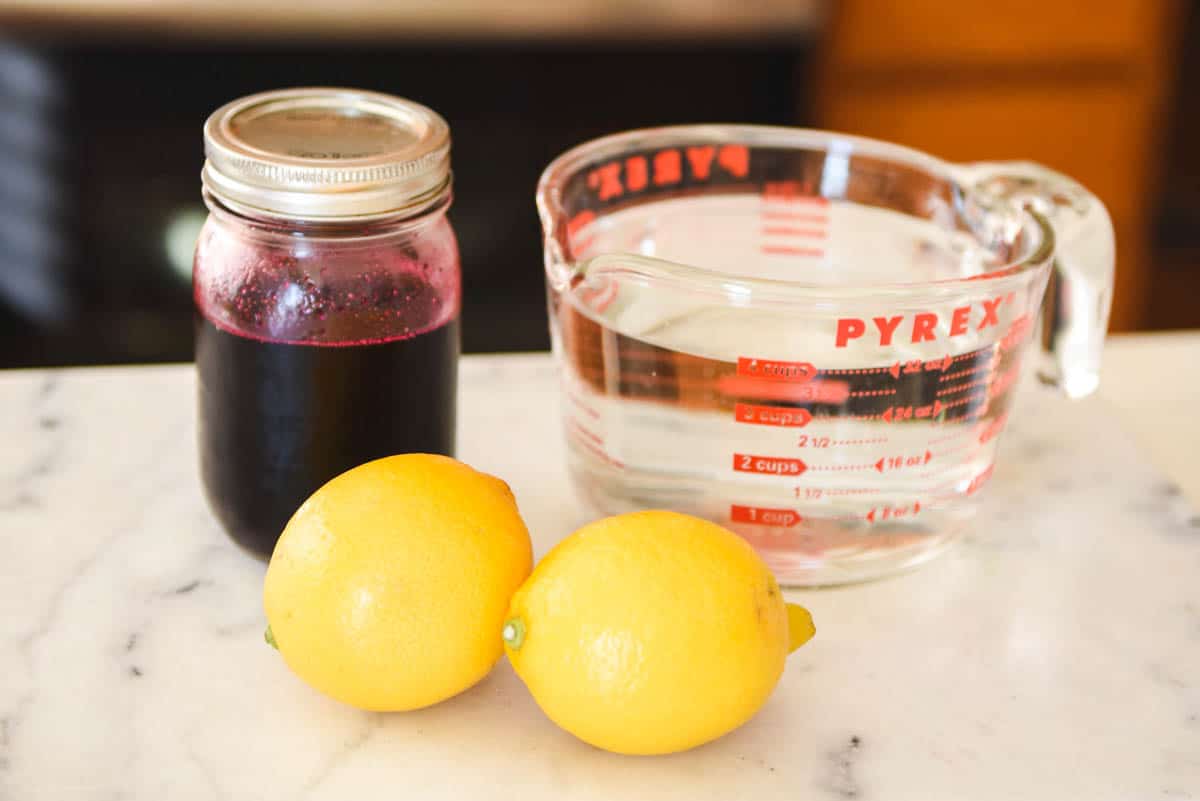 Ingredients to make a flavored lemonade with blueberry simple syrup.