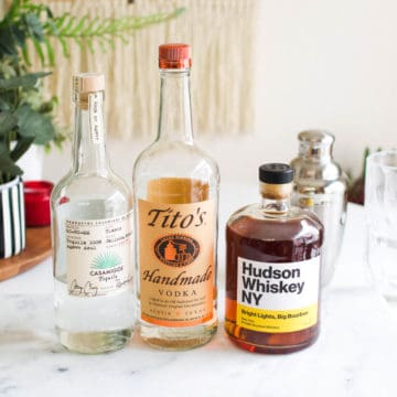 Bottle of vodka, bourbon and tequila on a table.