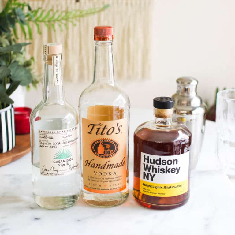 Bottle of vodka, bourbon and tequila on a table.