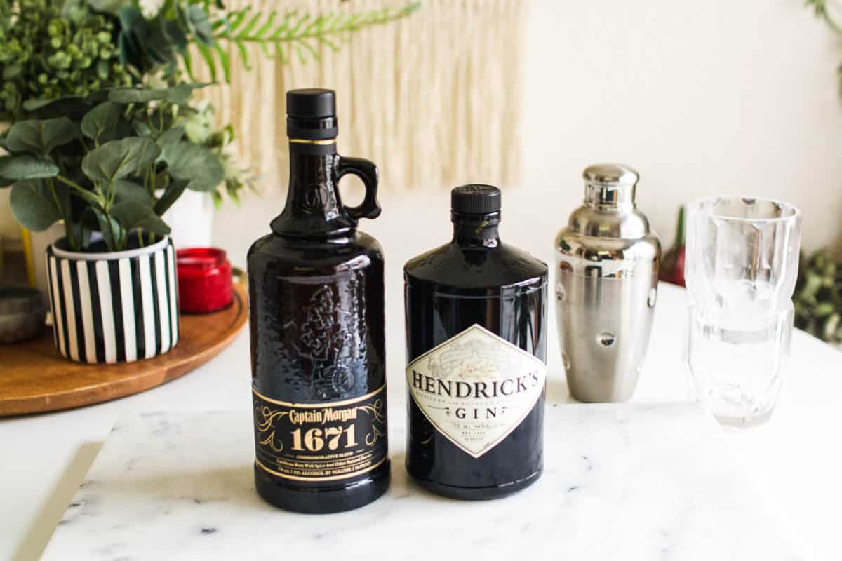 A bottle of spiced rum and gin on a table.