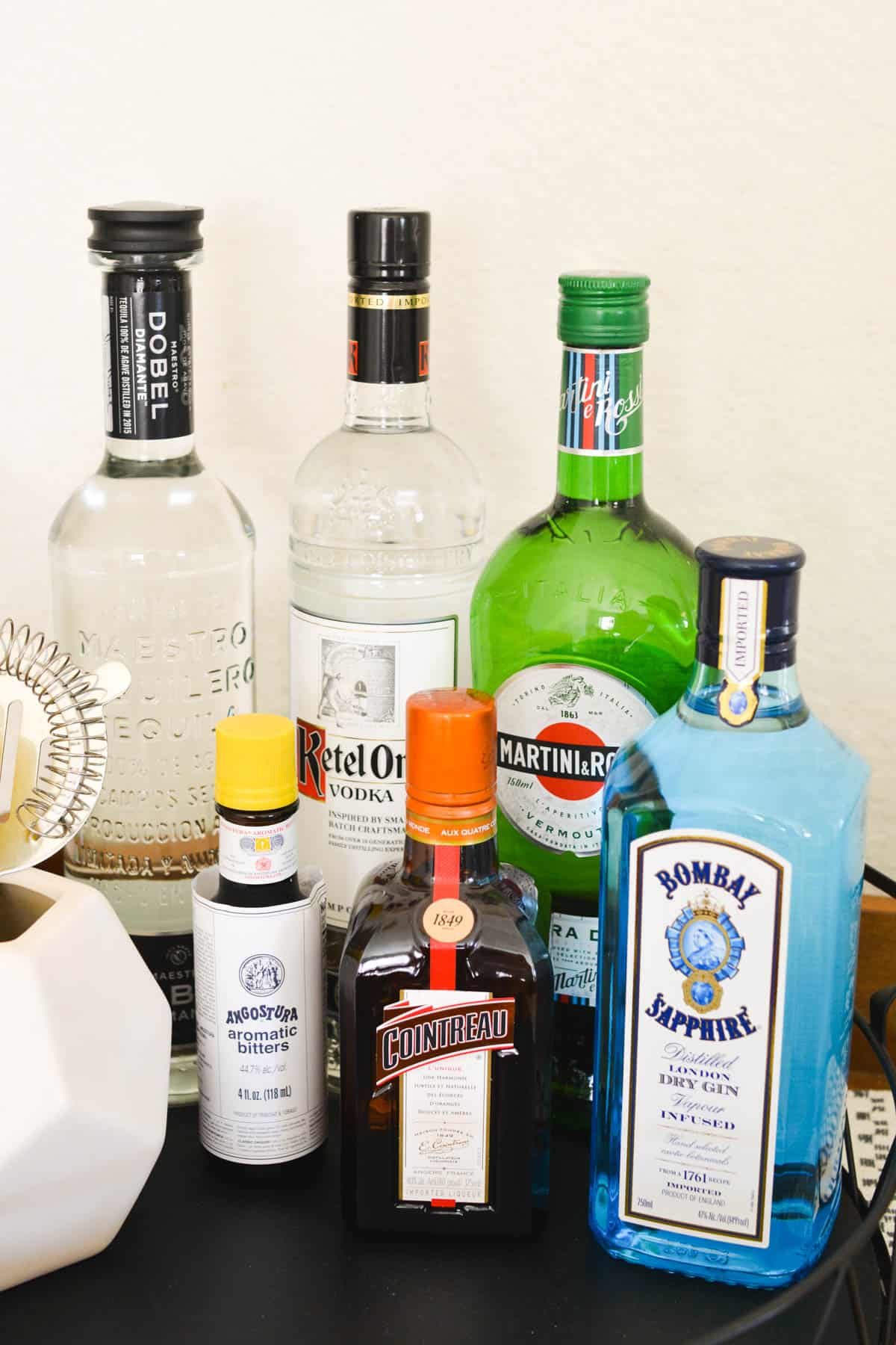 A bunch of bottles of liquor on a bar cart.