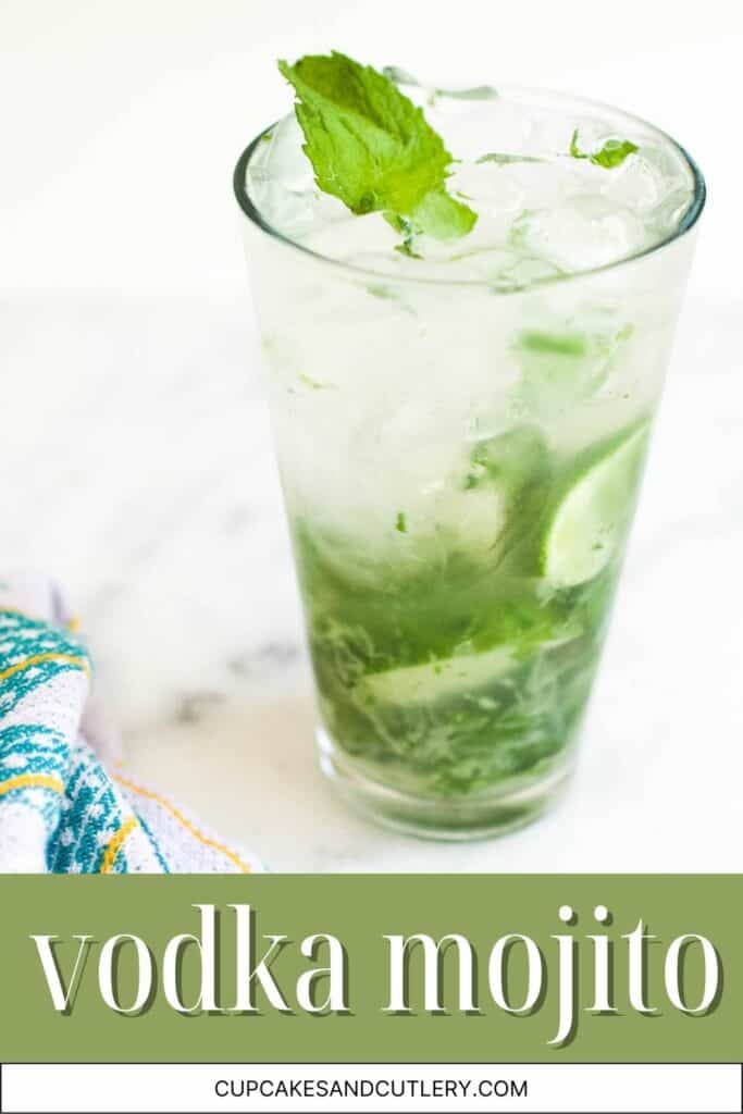 Text - Vodka Mojito with a high ball glass full of a cocktail over ice with pieces of lime and mint.
