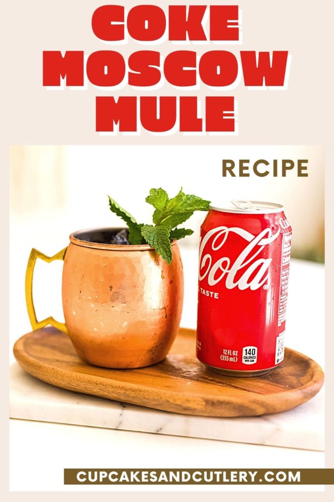 A can of coke next to a copper Moscow Mule mug.