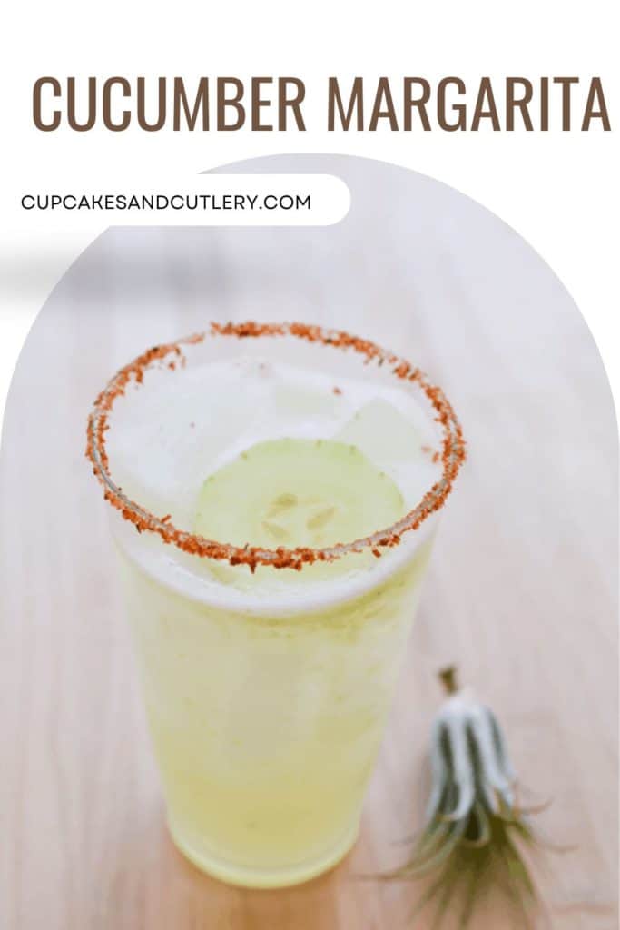 Text - Cucumber Margarita above an image of a tall glass with a Tajin rim holding a cucumber margarita.