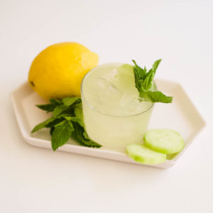 Close up of a cocktail glass holding a Mint Cucumber Lemonade Vodka Cocktail.