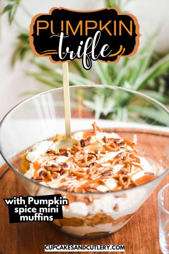 Text: Pumpkin Trifle with pumpkin spice mini muffins with a glass bowl holding a layered pumpkin dessert trifle topped with pretzels and nuts.