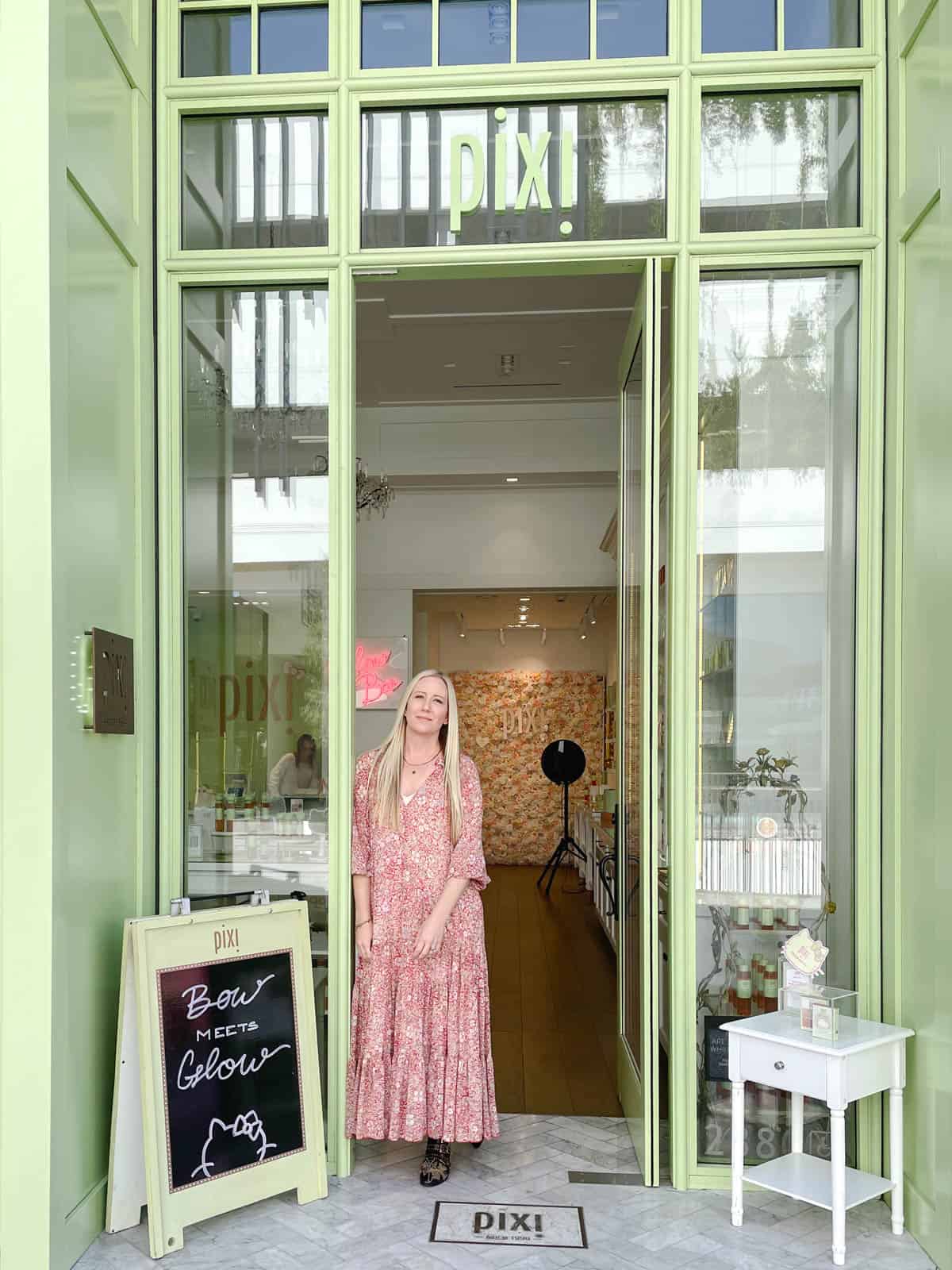 Woman standing in the doorway of the Pixi Boutique in Los Angeles.
