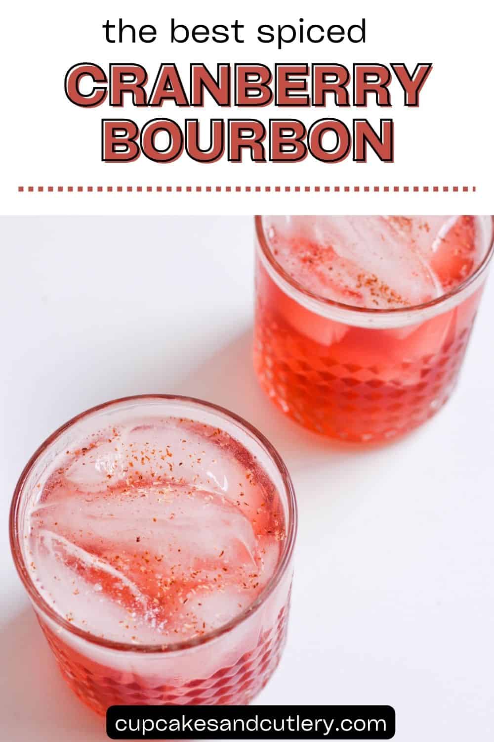 Text: The best spiced cranberry bourbon cocktail with two glasses holding a cranberry bourbon cocktail on a table.