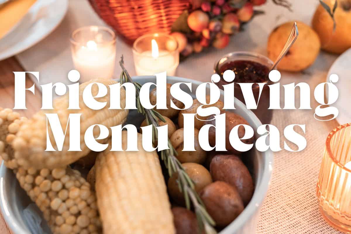A Friendsgiving table with side dishes and candles.