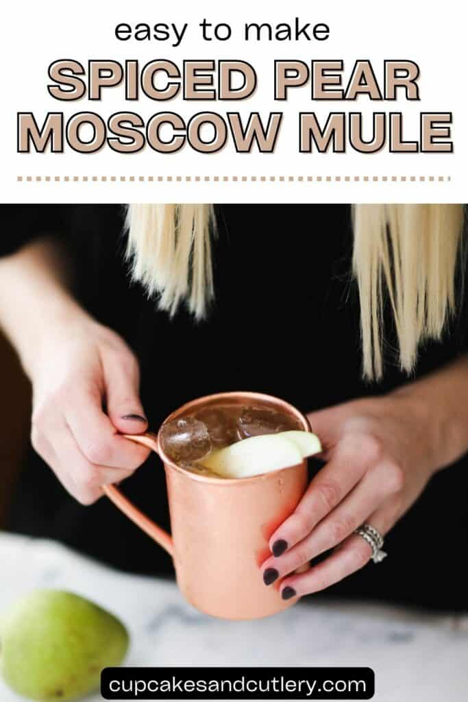 Text: Easy to make spiced pear Moscow Mule with a woman holding a copper mug with a cocktail topped with a pear slice.