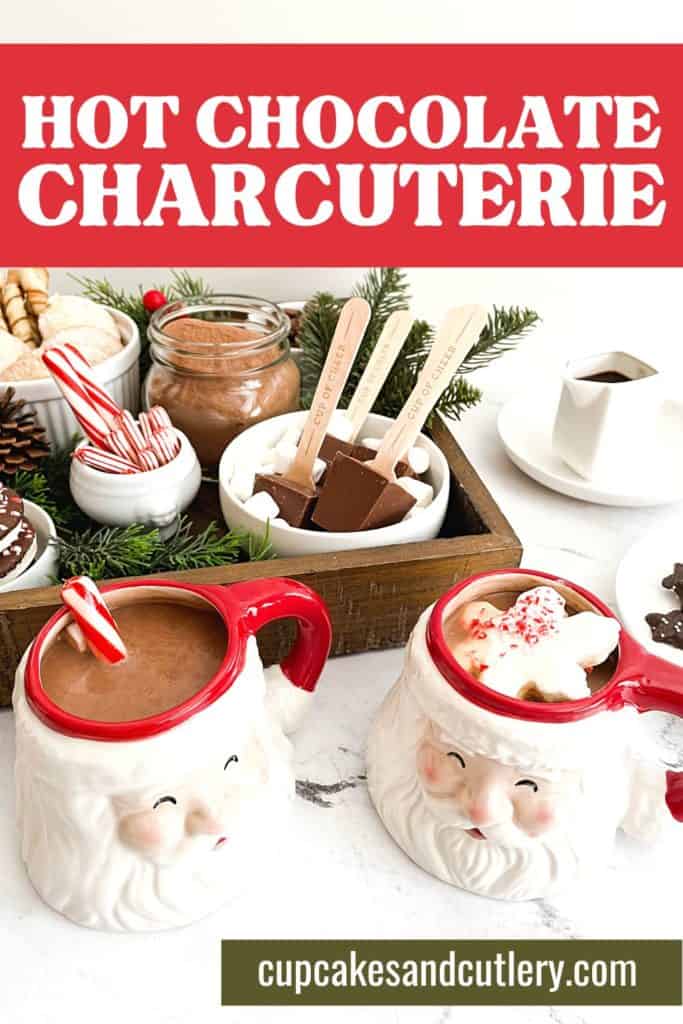 Santa mugs with hot chocolate next to a charcuterie board.