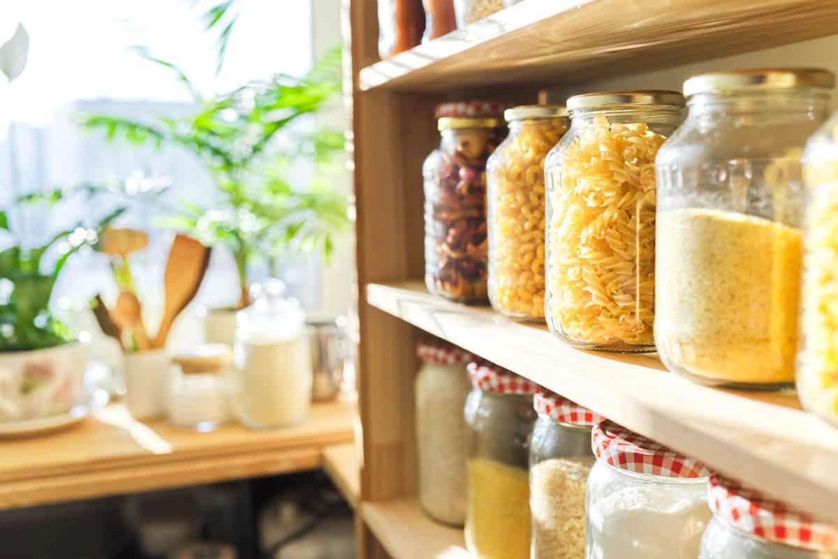 Organized jars of dry goods on a shelf. 