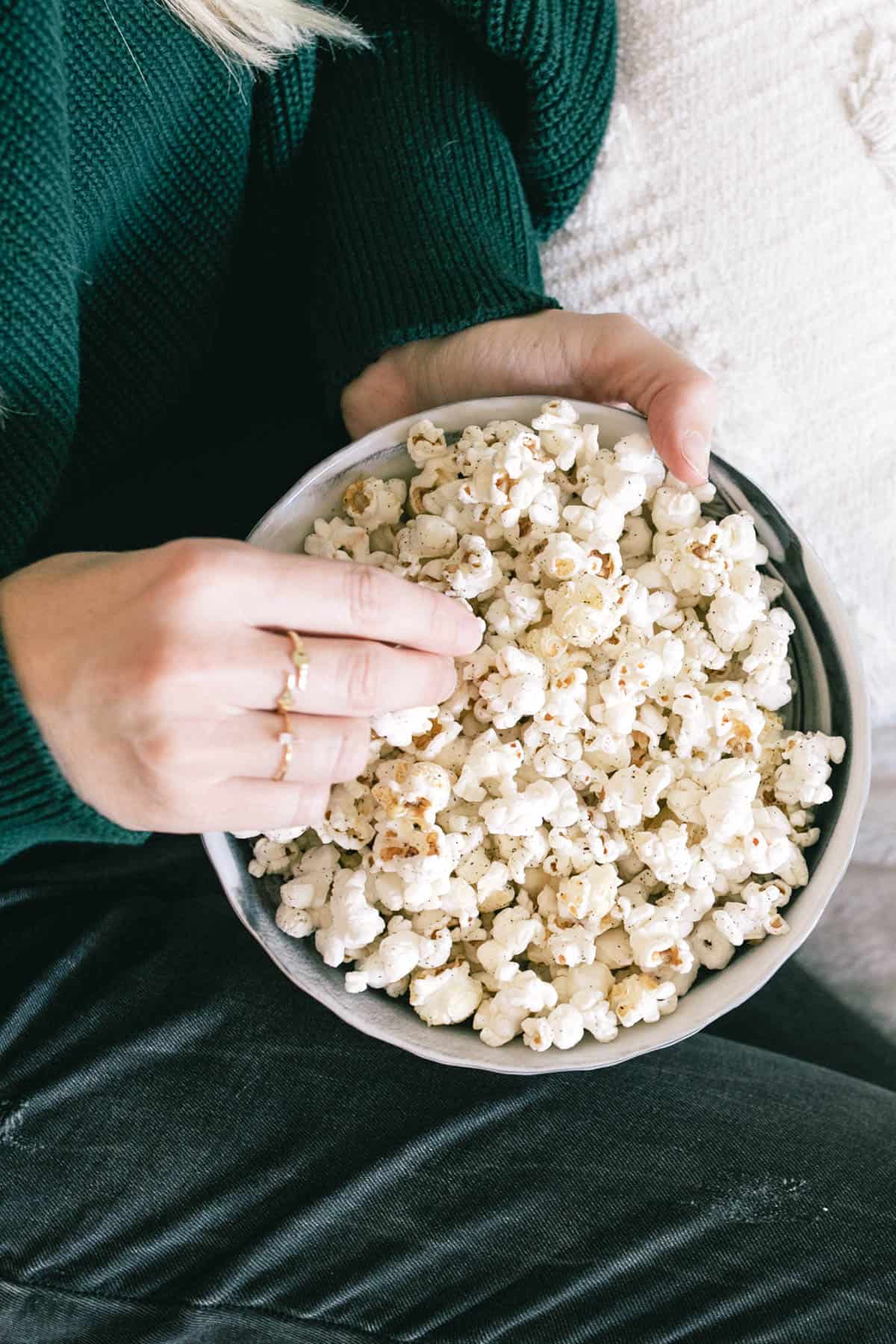 Close up of a woman with a bowl of popcorn.
