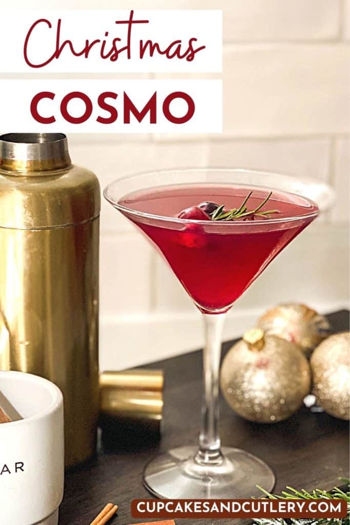 Text - Christmas Cosmo with a red martini next to Christmas ornaments.
