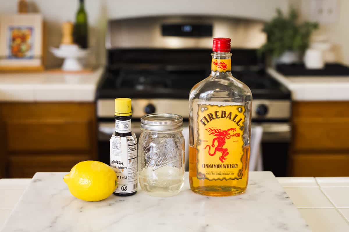 The ingredients to make a Cinnamon Whisky Sour on the counter.