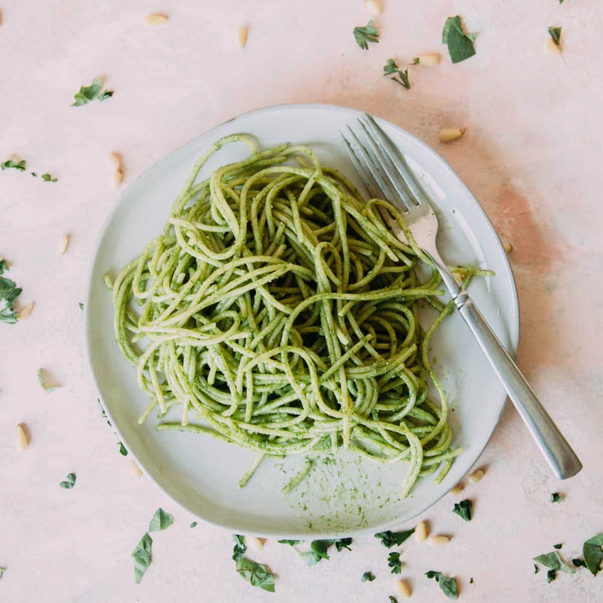 Zucchini noodles on a plate with a fork.