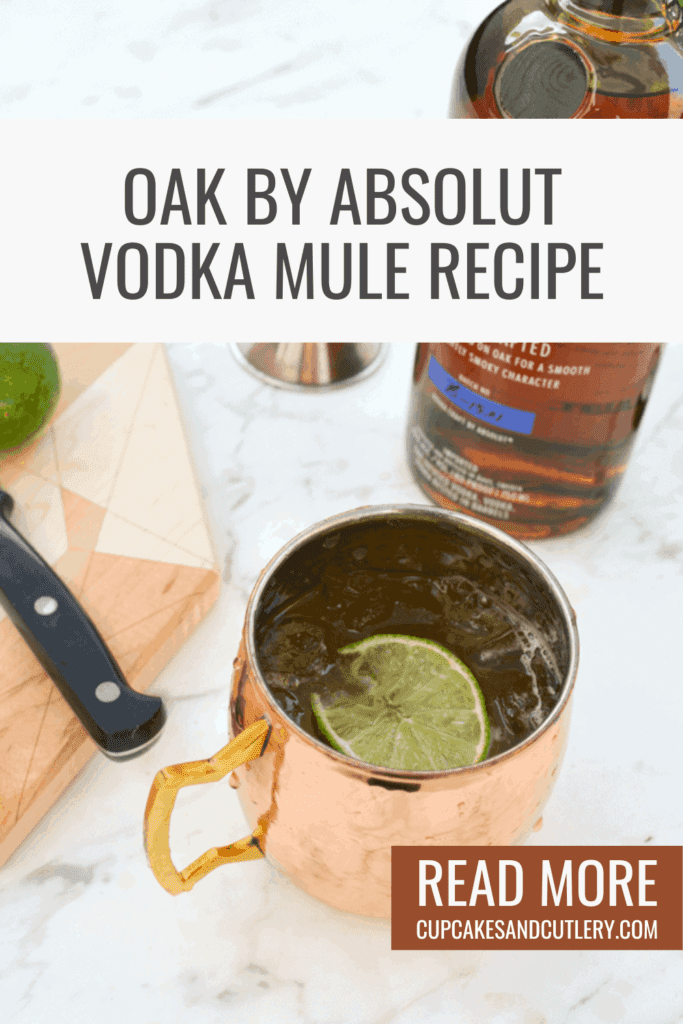 A copper mug holding a Vodka Moscow Mule made with Oak Absolut vodka on a table next to other ingredients.