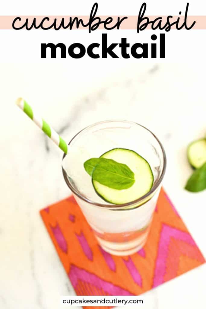 Text - Cucumber Basil mocktail with a glass topped with a slice of cucumber and a fresh basil leaf on a napkin.