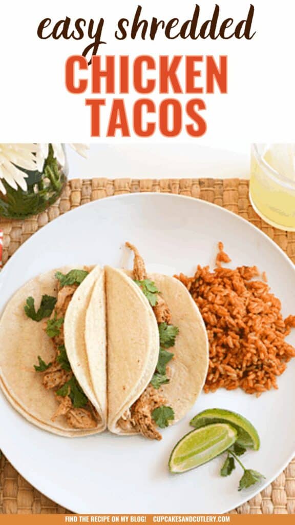 Text: Easy shredded chicken tacos with two soft tacos on a plate on a table with rice.