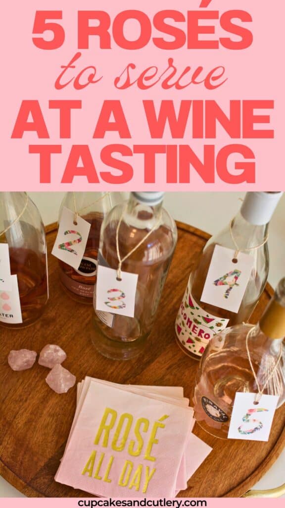 Text: 5 Rosés to serve at a wine tasting with a tray holding bottles of rose wine and pink napkins that say "rose all day".