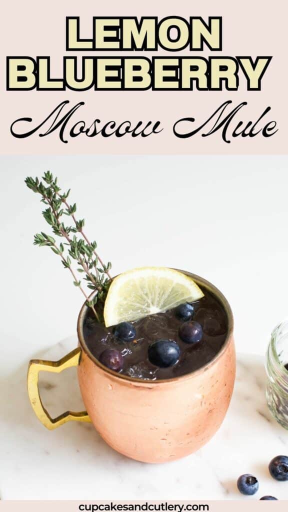 Text: Lemon Blueberry Moscow Mule with a copper mug holding a spring mule cocktail topped with thyme, blueberries and a lemon slice.
