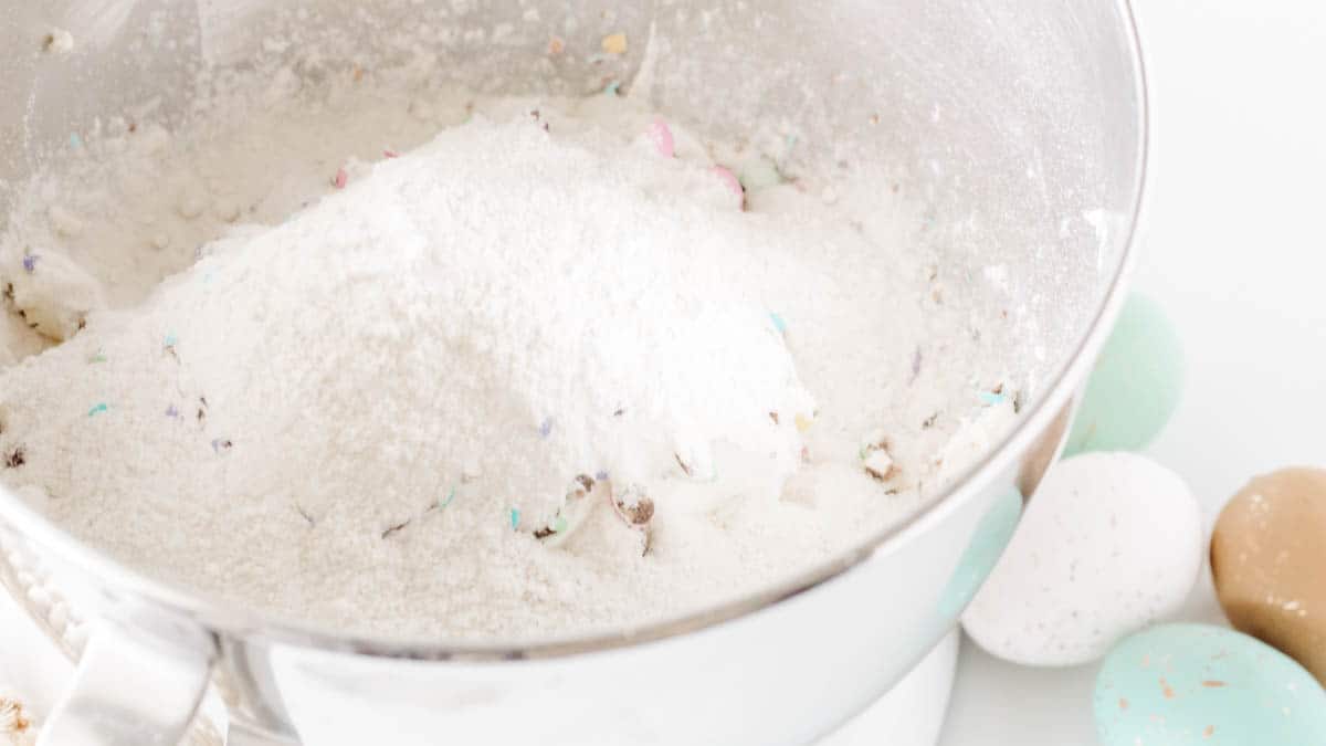 Dry cake mix and cream cheese in the bowl of a stand mixer.