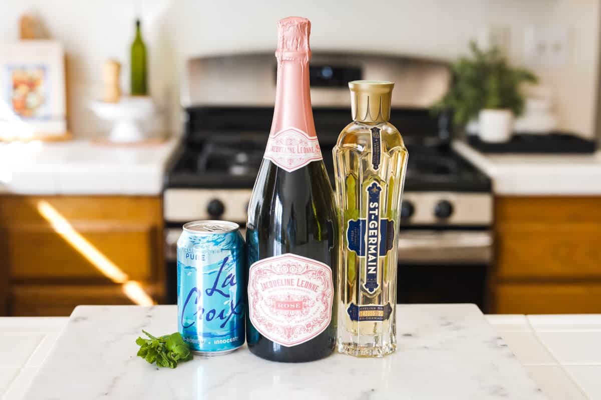 Ingredients to make a Hugo Spritz on the countertop.