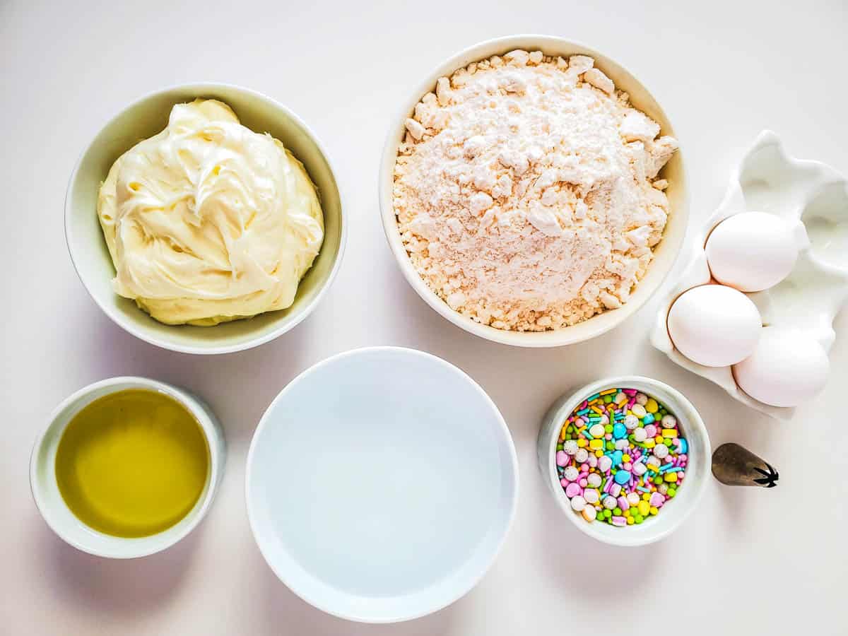 Ingredients in bowls on a counter to make Easter Pinata Cupcakes.