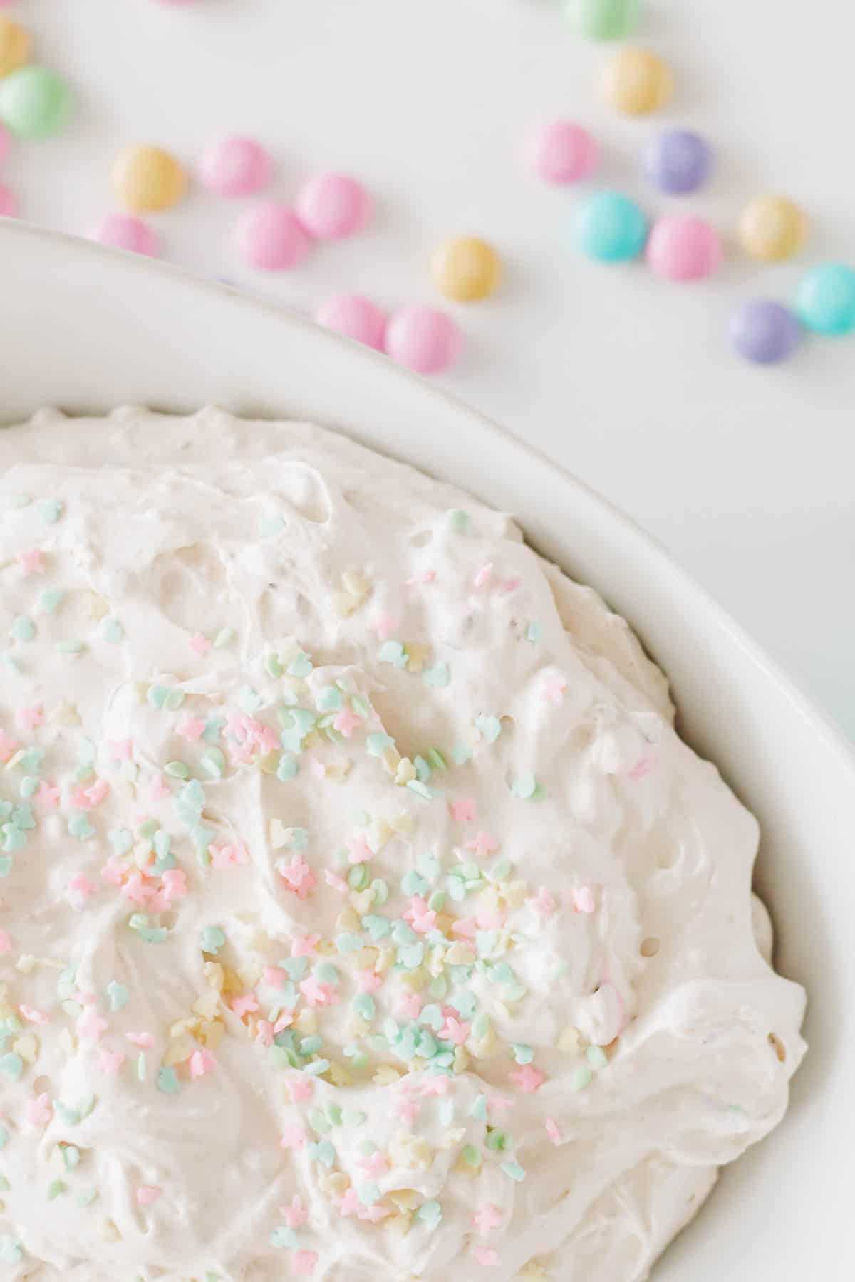 Close up of Easter sprinkles decorating the top of a cake mix dip dessert for Easter.