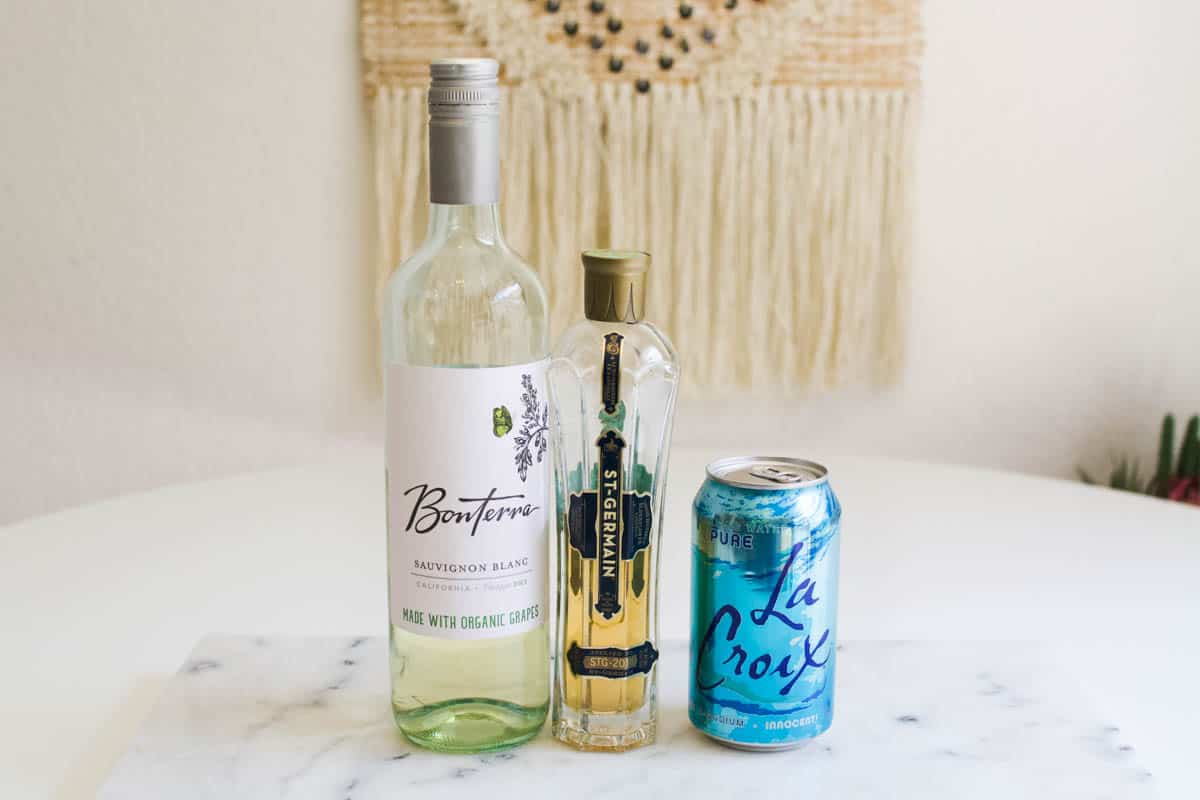 Ingredients you'll need to make a St. Germain Spritzer, white wine, St. Germain and club soda.