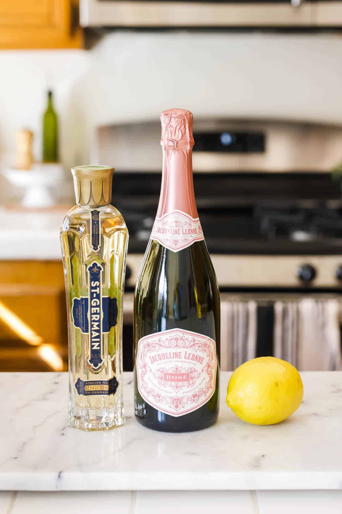 Ingredients for a St Germain Champagne Cocktail on a kitchen countertop. 