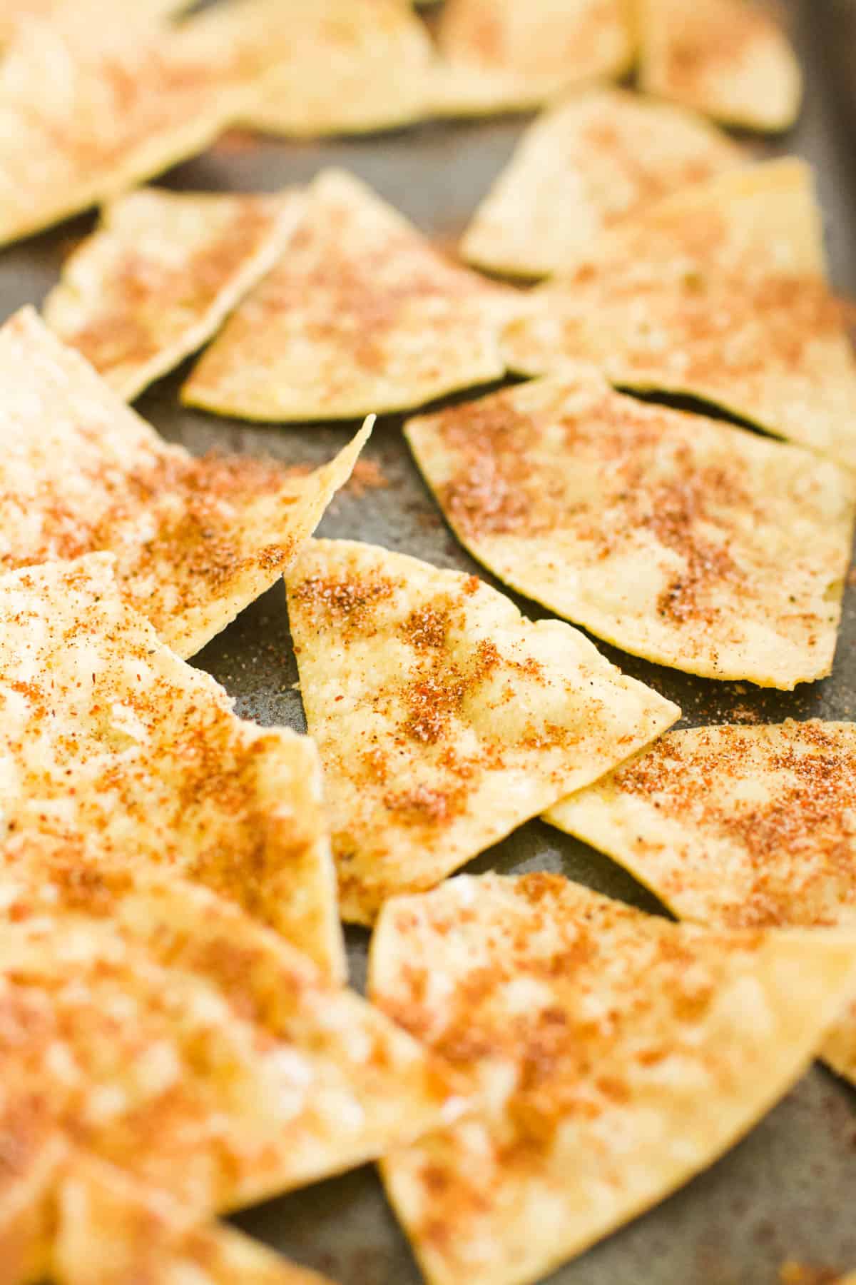Seasoned tortilla chips on a sheet pan.