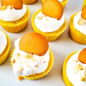 Close up image of a group of banana pudding cupcakes on a white countertop.