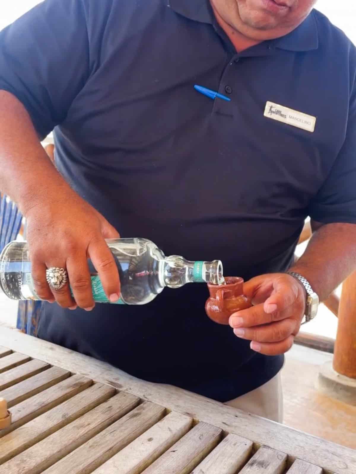 Man pouring a shot of Cazadores Tequila blanco.