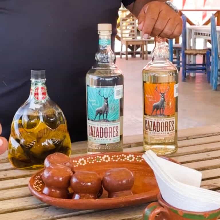 Blanco and reposado tequila from Cazadores on a table.
