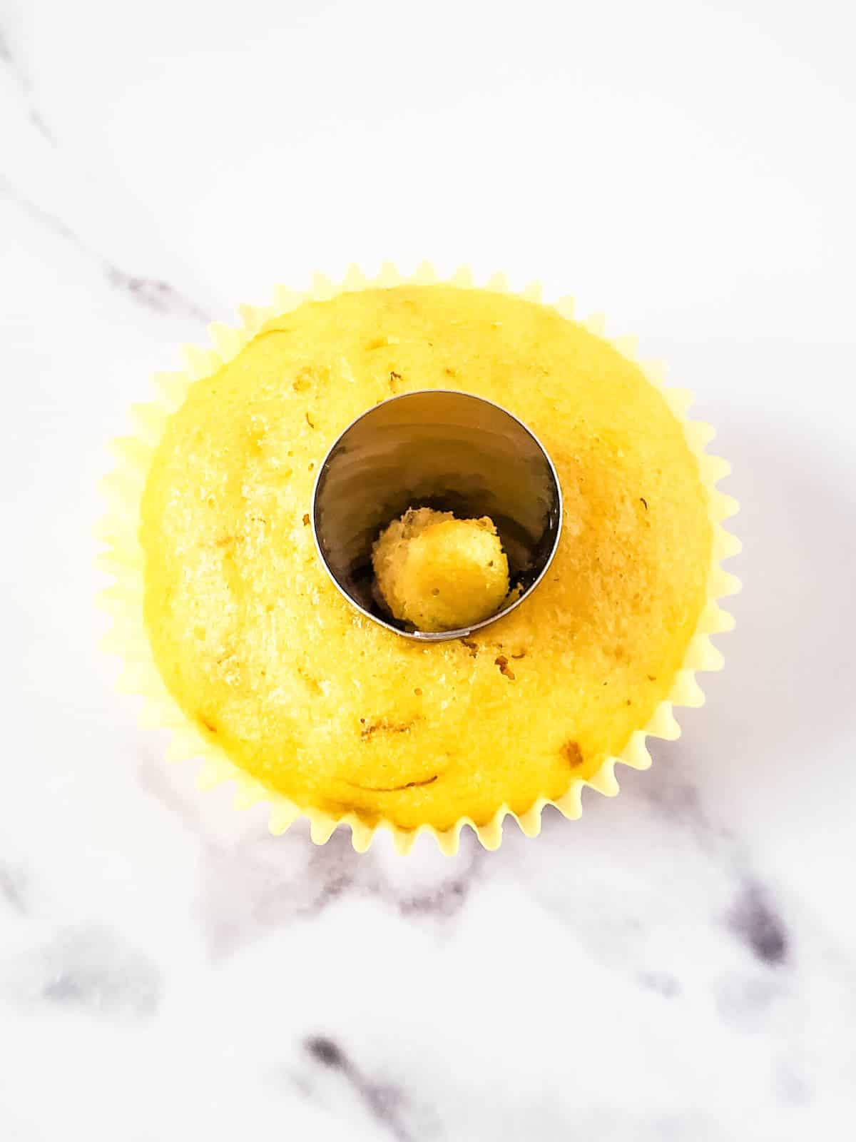 Creating a well in the cupcake with a frosting tip.